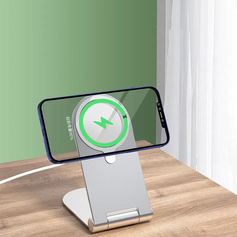 Silver vertical adjustable magnetic phone mounting bracket for iPhone12 on a desk.