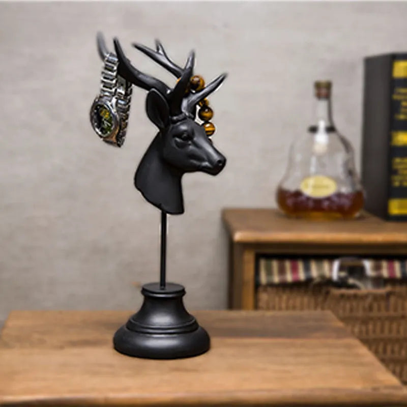 A solid natural resin animal-shaped home decoration in black, shown from the side.