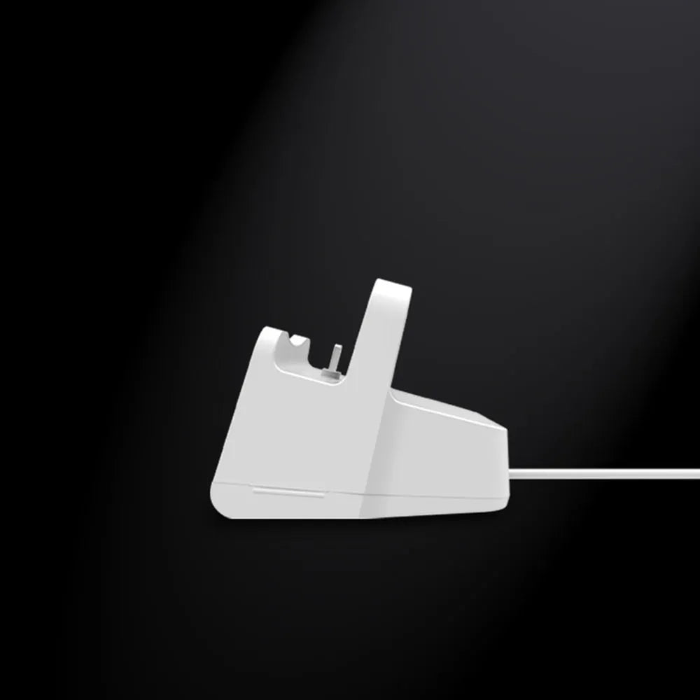 White headphone charging base with minimalist design on desk surface