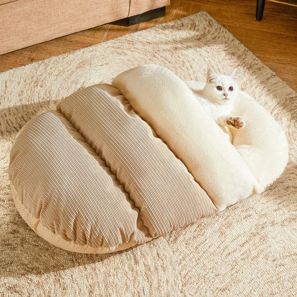 Slipper-shaped cat cave bed with corduroy exterior and self-warming design on hard flooring