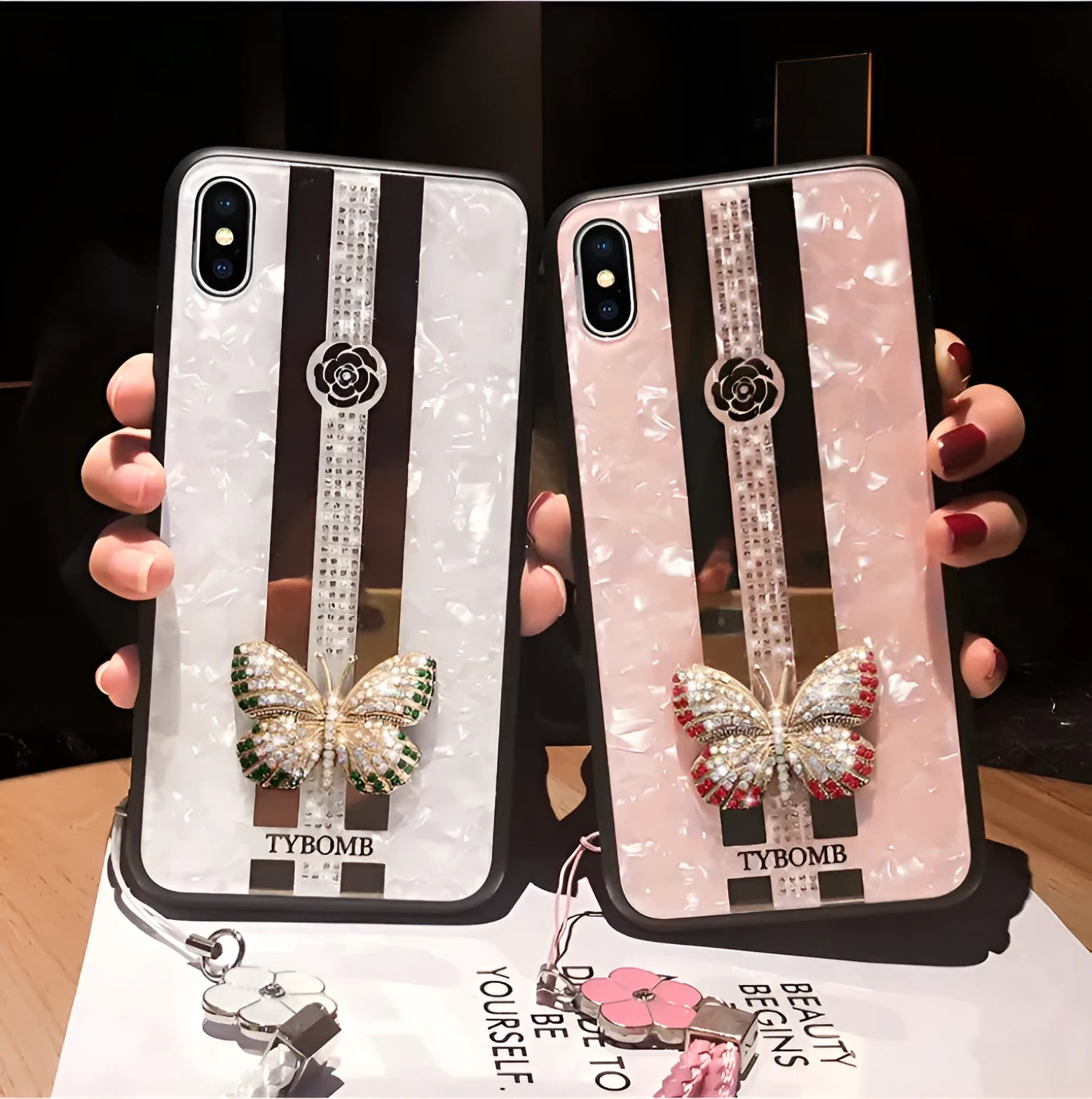 Clear acrylic iPhone case with a sparkling butterfly design and a reflective mirror surface.