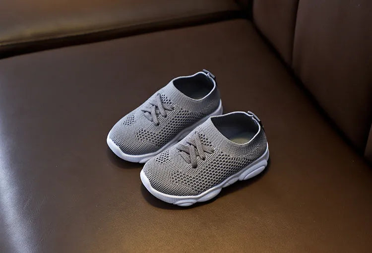 Children's lazy slip-on shoes in fabric with non-slip rubber sole, shown in available colours.