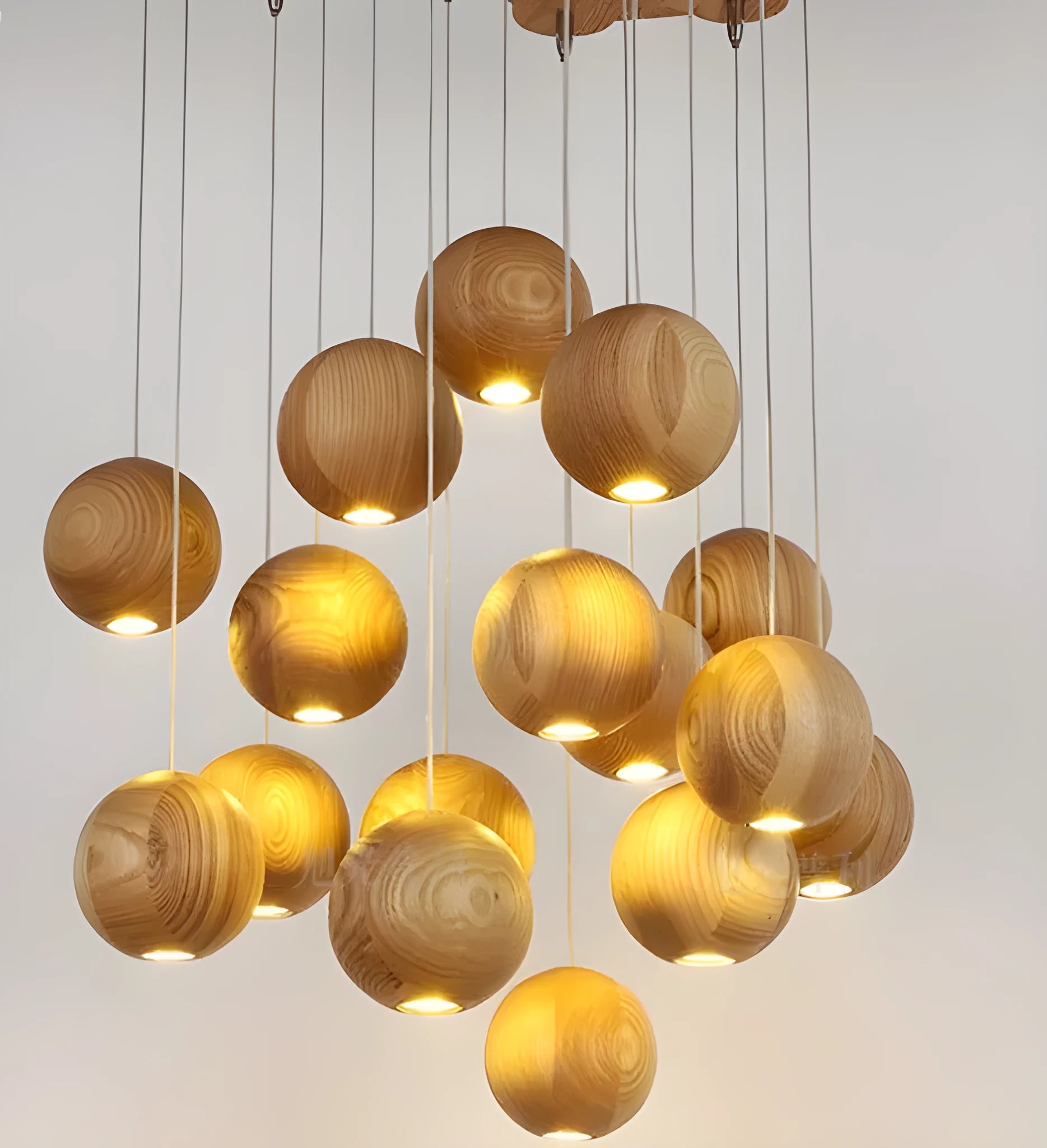Nordic style solid wood ball chandelier hanging from ceiling with adjustable cord.