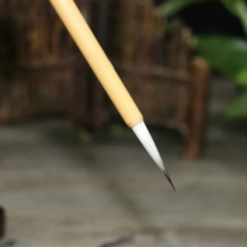 Set of four Chinese calligraphy brushes with gold pine branch design and mixed wolf hair and wool bristles