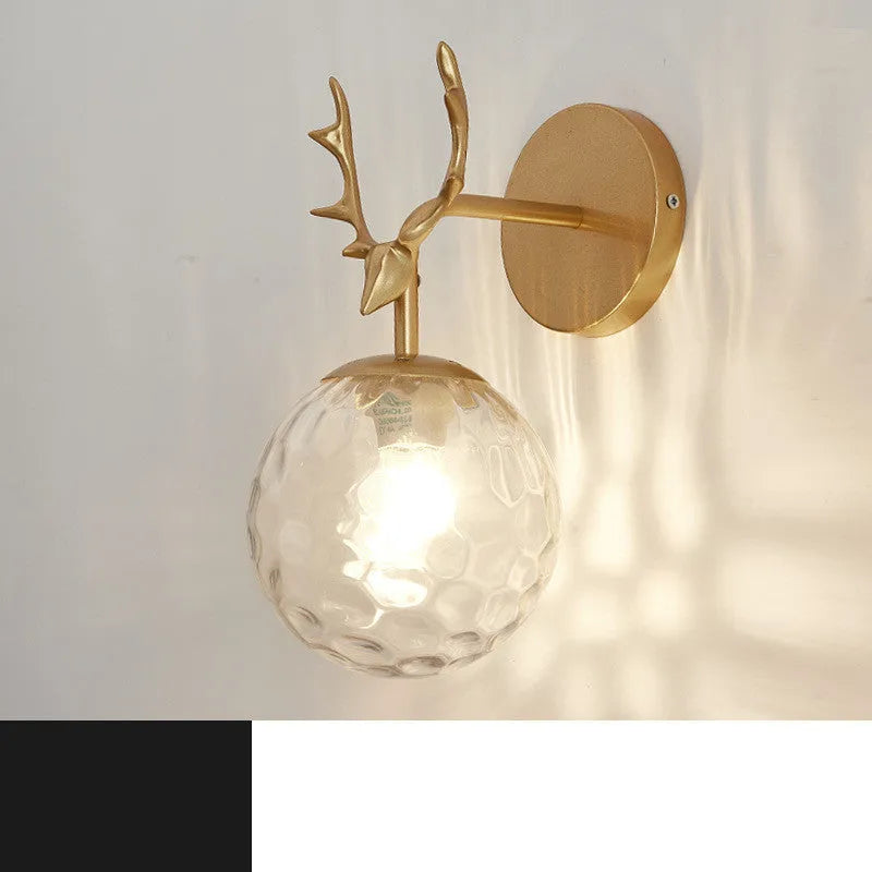 Minimalist round glass wall sconce with textured shade and black frame mounted on a white wall.