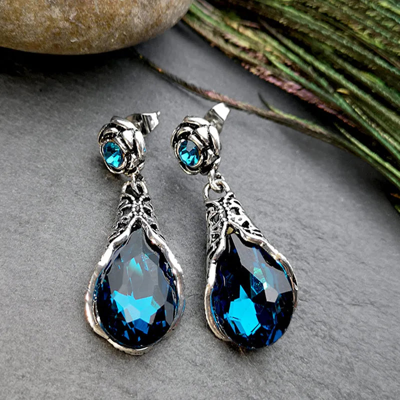 Retro peacock blue crystal water drop drop earrings on a light background