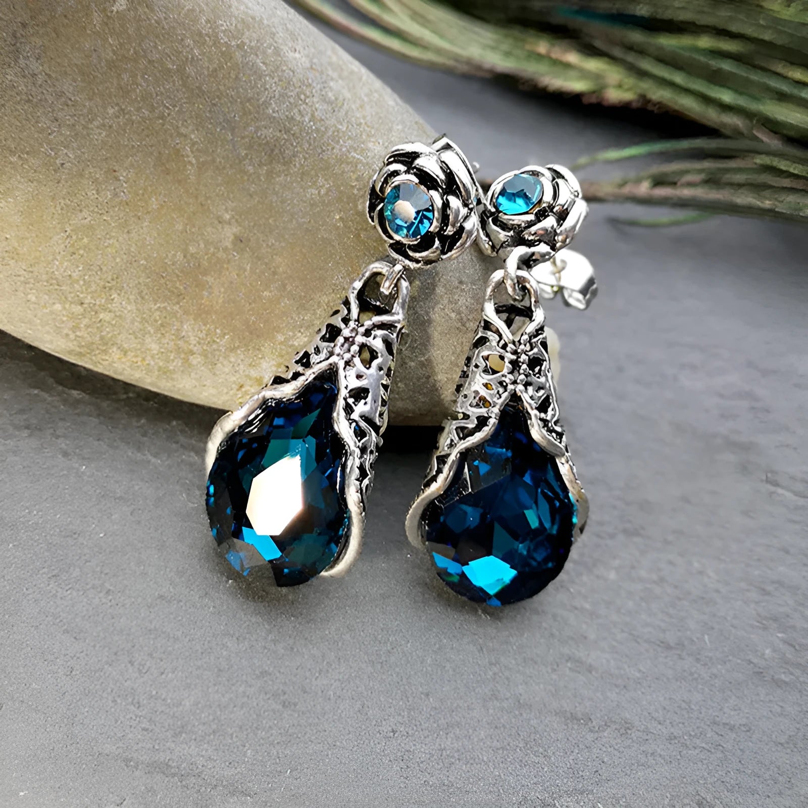 Retro peacock blue crystal water drop drop earrings on a light background