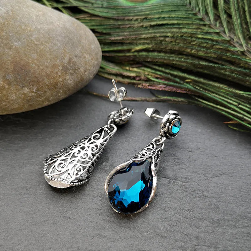 Retro peacock blue crystal water drop drop earrings on a light background