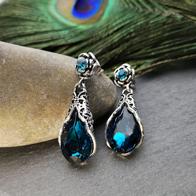 Retro peacock blue crystal water drop drop earrings on a light background