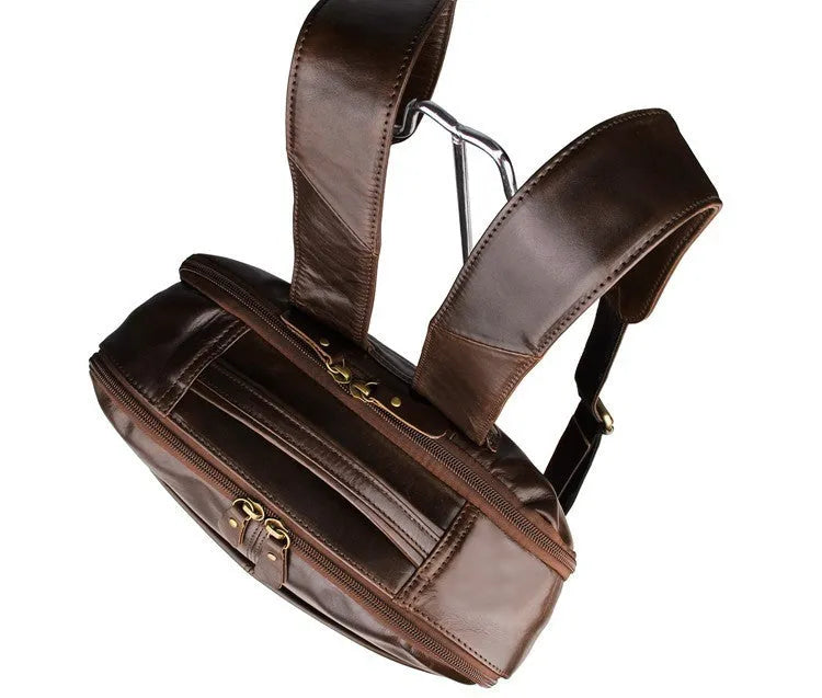 Top layer leather computer backpack in brown colour with zip closure designed to fit a 15 inch laptop