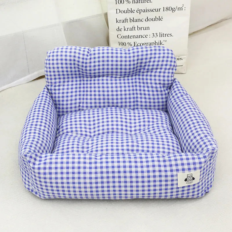 Grey and blue plaid cloth car-mounted dog travel nest shown in two size options.