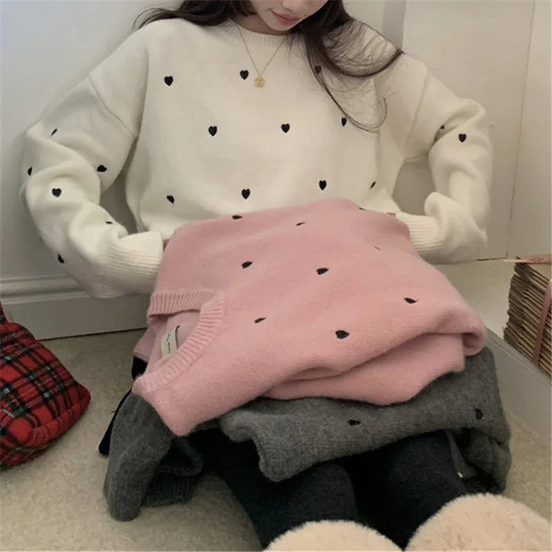 Women's loose cream pullover sweater with embroidered red love pattern on the front.