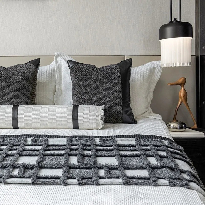 Modern grey and white plaid bed runner blanket and pillow set arranged on a double bed