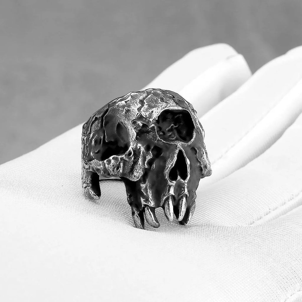 Alloy one-eyed skull ring in a retro electroplated finish, shown on a finger.