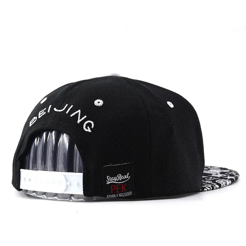 Adjustable black cotton baseball cap with embroidered lettering on the front, showing the dome crown and strap.