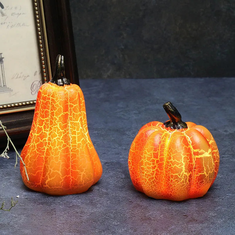Three LED pumpkin lanterns in different sizes with realistic surface cracks and candle-like glow