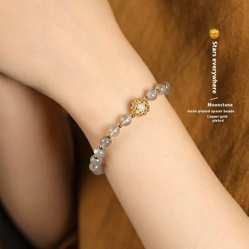 Hand-woven crystal bracelet with gray moonstone, sunstone, and strawberry quartz beads in pastoral style.