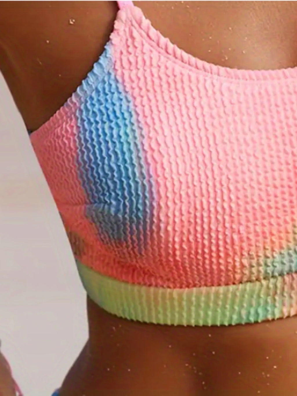 Women's blue and orange tie-dye pleated split bikini made from polyester.