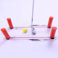 Red plastic putting practice mirror for golf training aid on green surface