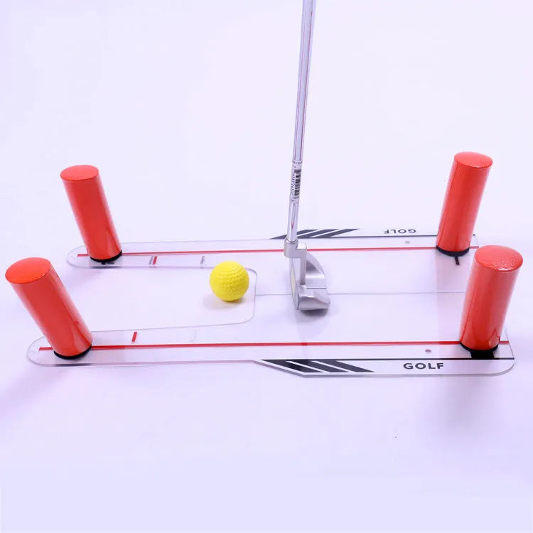 Red plastic putting practice mirror for golf training aid on green surface