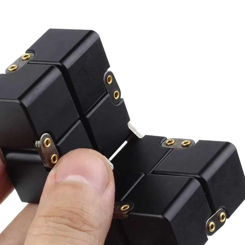 Zinc alloy infinity cube fidget toy showing black and silver colour options, sized at 4cm.