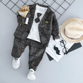 Grey three-piece children's suit with blazer, waistcoat, and trousers on a hanger.