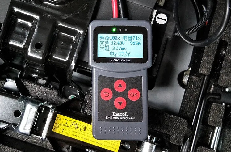 Black car battery tester with display and cables, measuring 15x6x3 cm