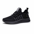 Men's black casual sports shoes with cross straps and a woven Flying Weave upper on a flat wear-resistant sole.