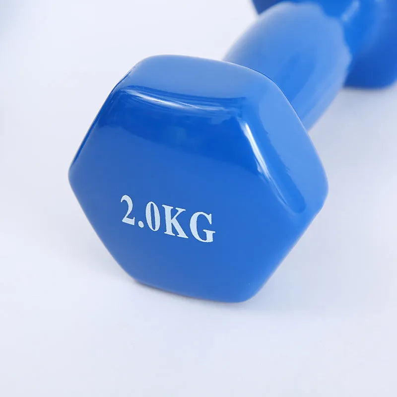 Set of bright coloured plastic fitness dumbbells showing 0.5kg, 1kg, and 1.5kg weights on a floor.
