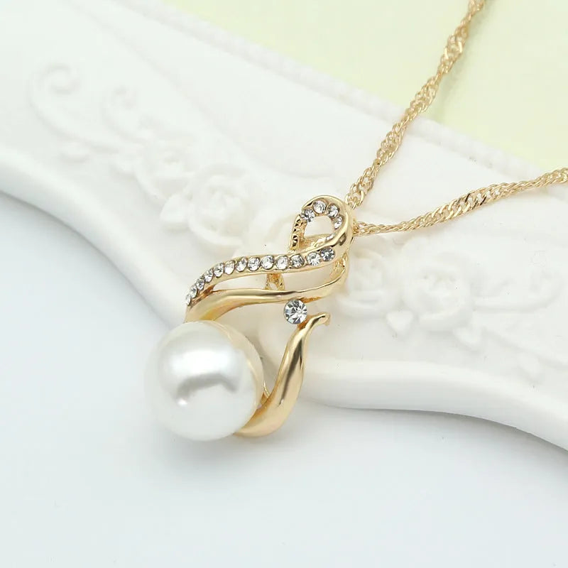Gold tone pearl necklace and earrings set on display showing CA410-A colour with diamond-cut alloy finish