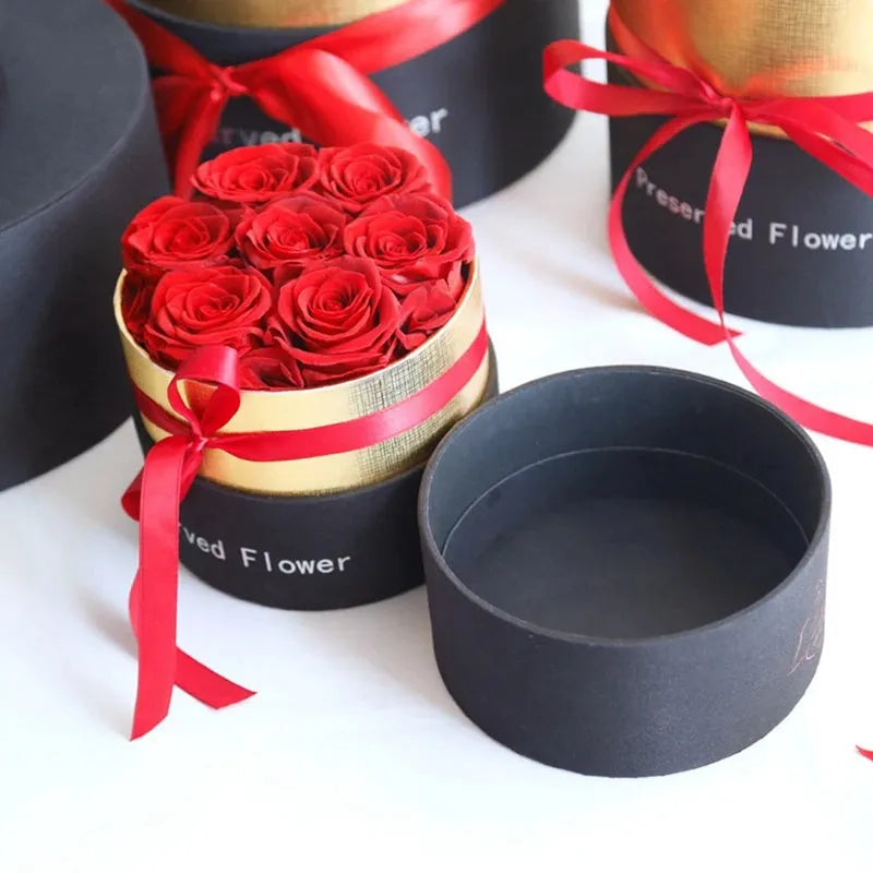 Luxury gift box open to display preserved real red roses, a Valentine's Day gift set.