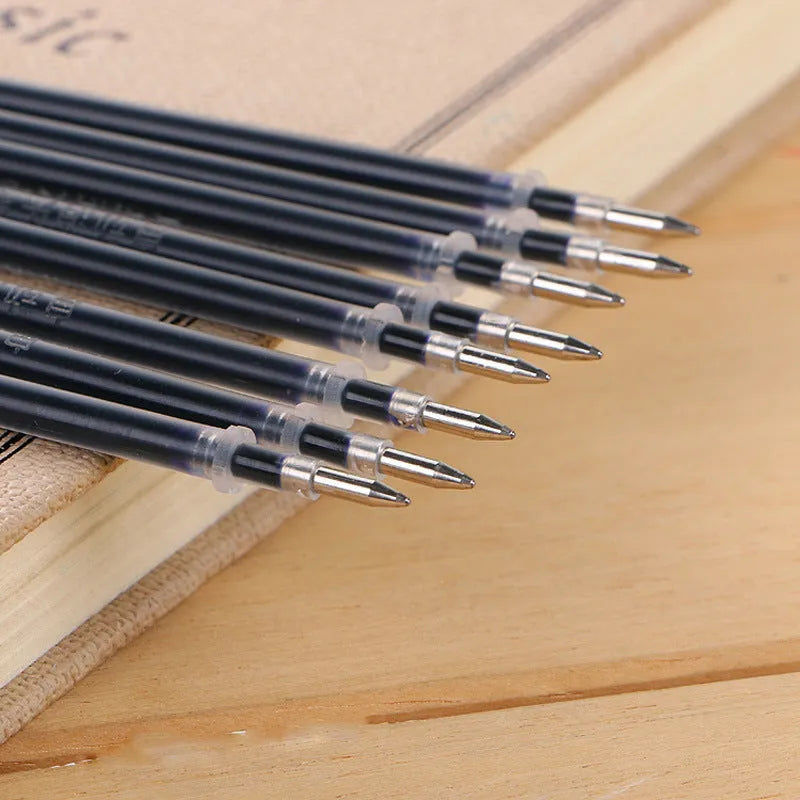 Automatic fade and disappear pen set showing pen holder, case, and eight refills on a notepad.