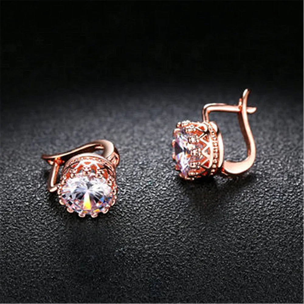 Korean retro crown design ear clip earrings in rose gold or white gold finish with white diamond accents.