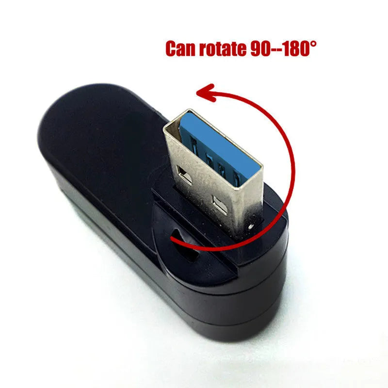 Black and white USB 3.0 four-port rotary hub on a desk next to a laptop