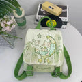 Mint green backpack with spliced design, polyester fabric, and sandwich pockets on neutral background.