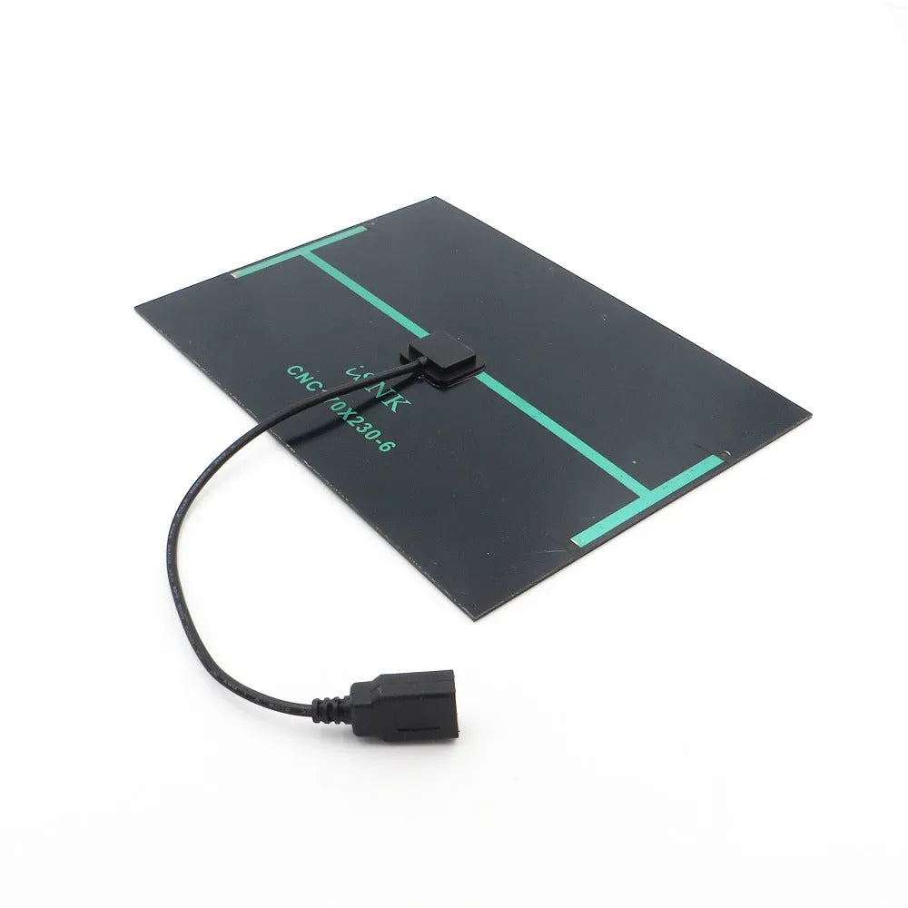 Portable solar panel unit with a small fan and a USB charging port for mobile phones.