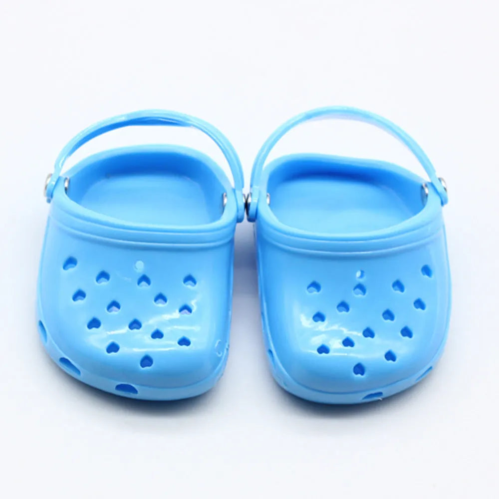 Plastic doll beach slippers in blue, red, yellow, and green colours.