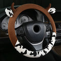 Black plush steering wheel cover with protective handle on car steering wheel