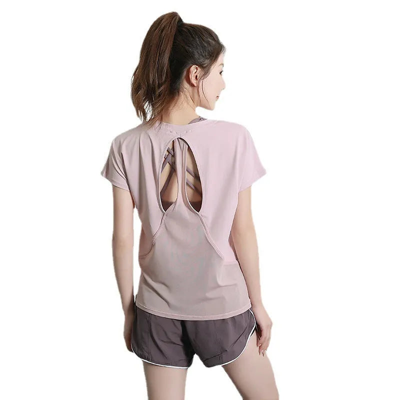 Women's short sleeve polyester sports t-shirt in pink, shown for fitness and leisure wear.