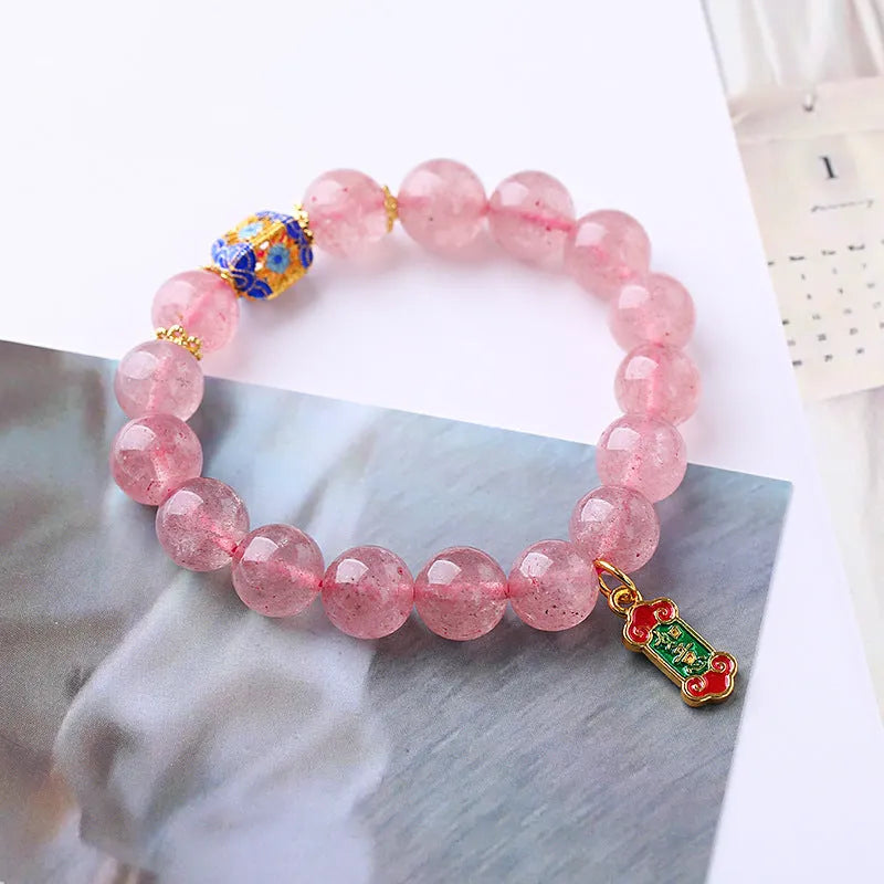 Pink strawberry quartz crystal bracelet with hand-woven Ruyi symbols and text elements