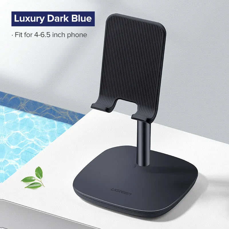 Folding plastic desktop stand holding a smartphone in black colour on a desk