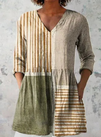 A loose-fit women's dress with a wave print pattern, wide waist, and three-quarter length sleeves.