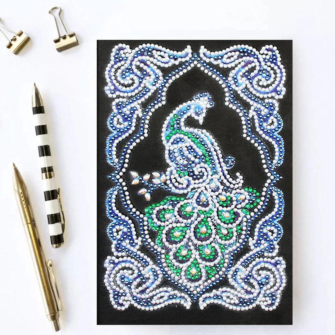 Peacock Beauty A5 diamond painting notebook with coloured resin drills on a black cover.