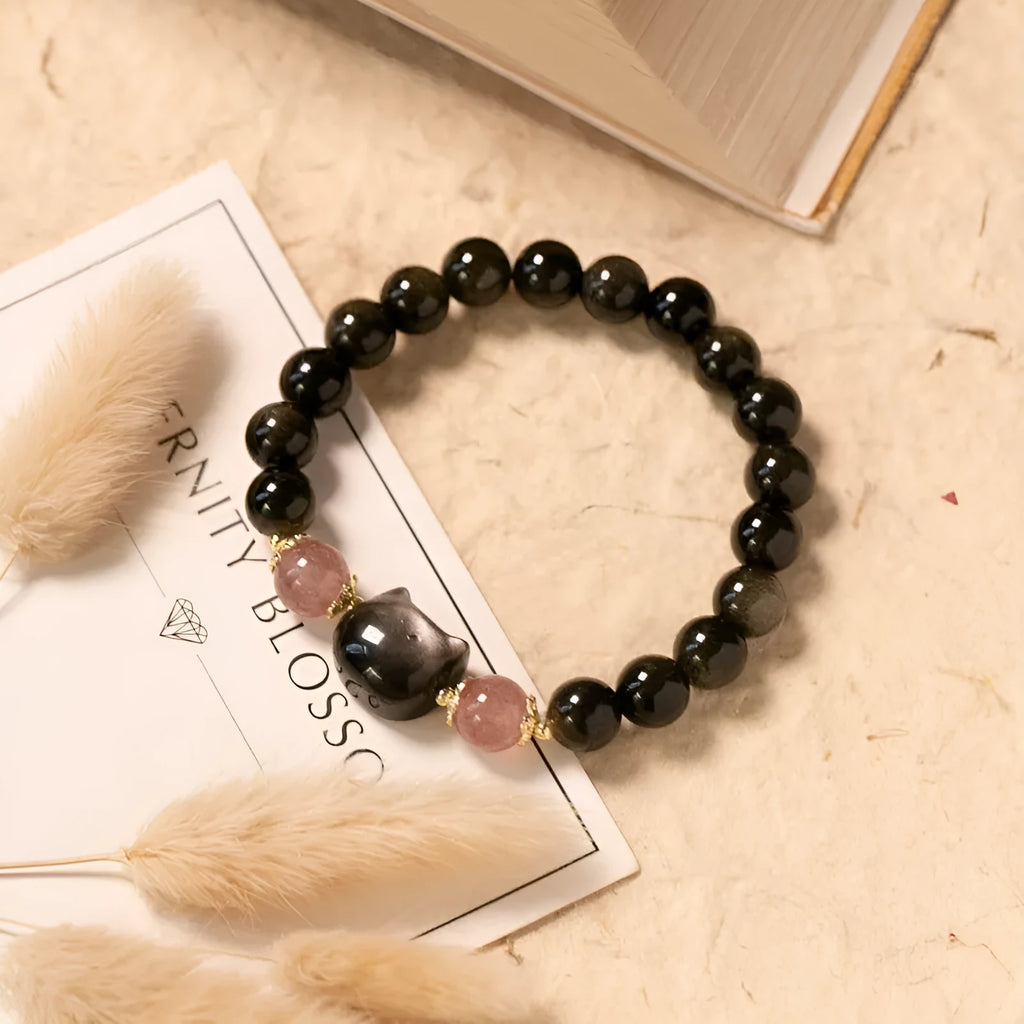 Black obsidian bead bracelet with cat charm on adjustable fastening