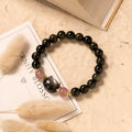 Black obsidian bead bracelet with cat charm on adjustable fastening