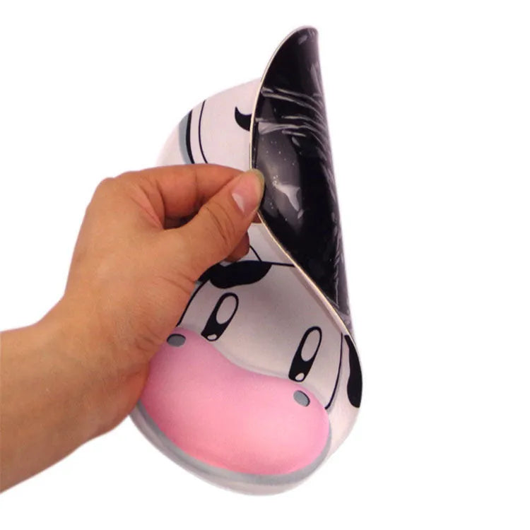Cow silicone wrist mouse pad with soft hand rest and non-slip base on a desk