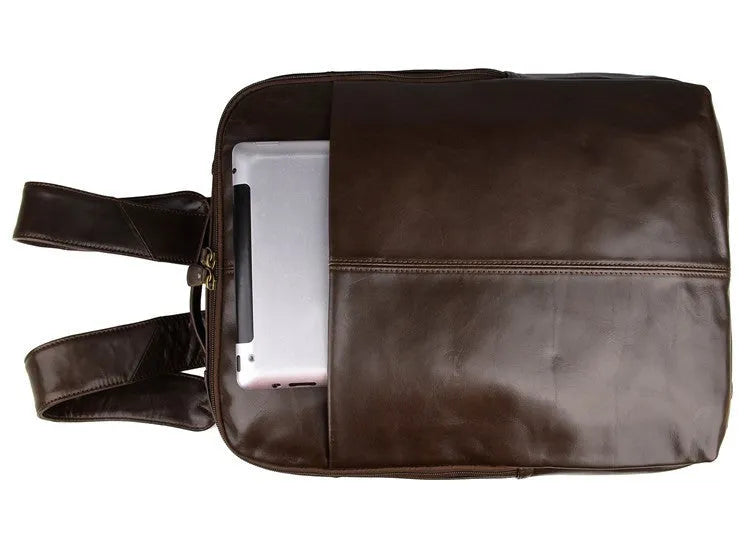 Top layer leather computer backpack in brown colour with zip closure designed to fit a 15 inch laptop