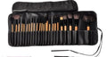 24 professional makeup brushes with wooden handles in a black PU gift bag