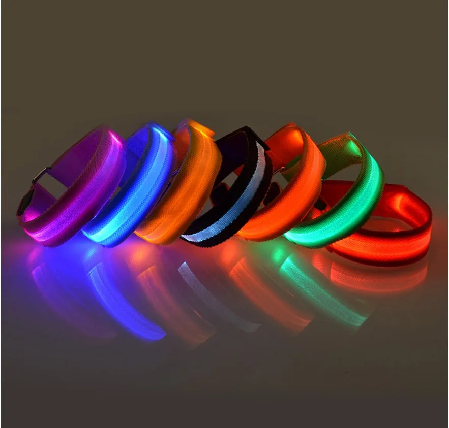 Illuminated arm band with LED lights on a black ribbon, adjustable, showing blue and red colours