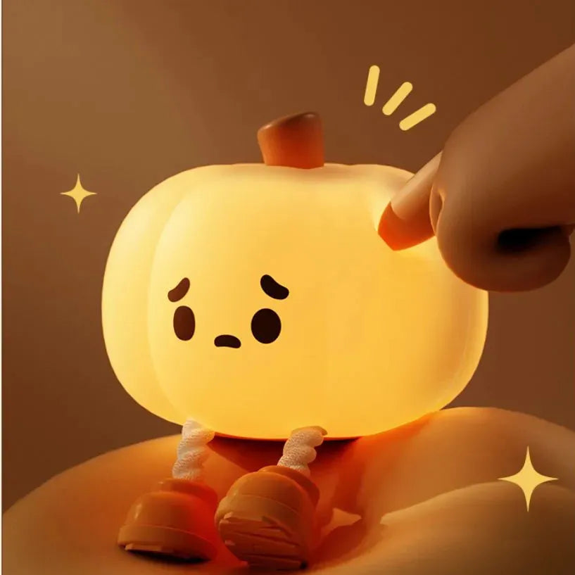 Soft orange silicone pumpkin-shaped night light with a warm glowing light.
